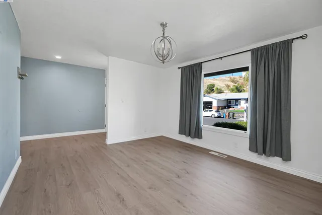a view of a kitchen with a refrigerator a sink and cabinets