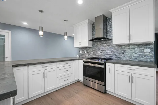 a kitchen with stainless steel appliances granite countertop a refrigerator and a sink