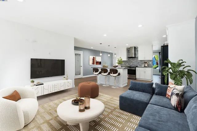a view of a hallway with wooden floor and a bathroom