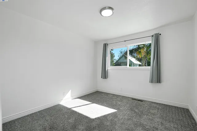 a bathroom with a granite countertop sink toilet and shower curtains