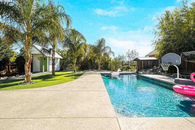 an aerial view of a house with a yard and fountain in front of it