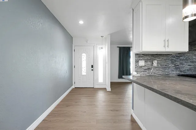 a view of a kitchen with a sink and a refrigerator
