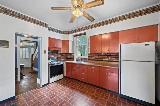 a kitchen with stainless steel appliances granite countertop a refrigerator a oven a sink and dishwasher