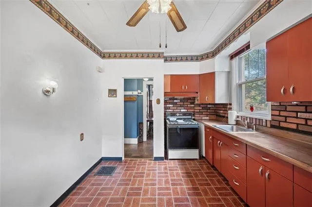 a kitchen with stainless steel appliances granite countertop a refrigerator a sink dishwasher a stove and white cabinets