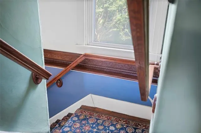 a view of a room with wooden floor and windows