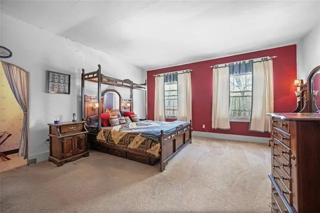 a bed sitting in a room next to a window