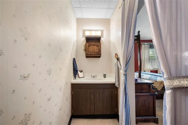 a view of a house with a yard and potted plants