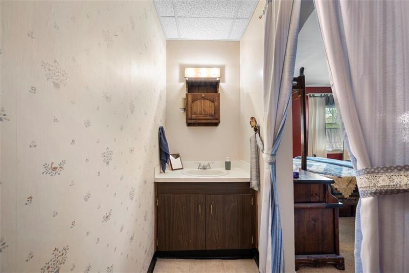 508 Cascade Road Pittsburgh, PA 15221 - Photo 25 of 37 a bathroom with a sink a toilet and mirror