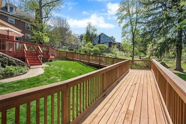 a view of balcony with wooden floor and fence