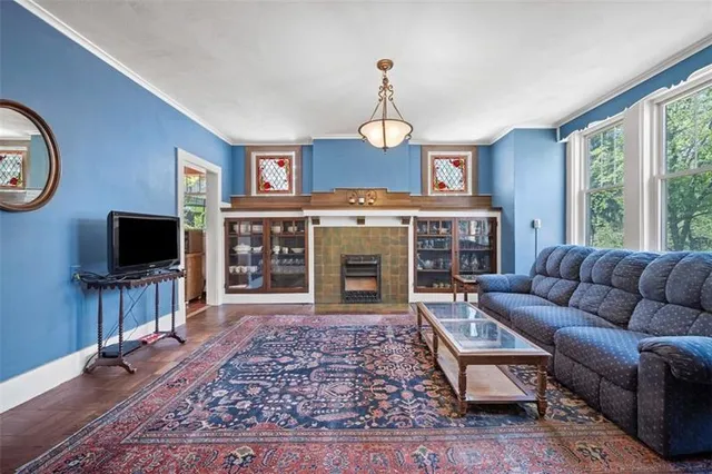 a living room with furniture a flat screen tv and a fireplace
