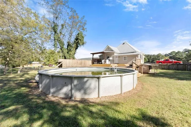 a view of a house with a yard and sitting area