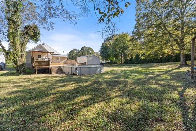 a view of a large house with a big yard and large trees