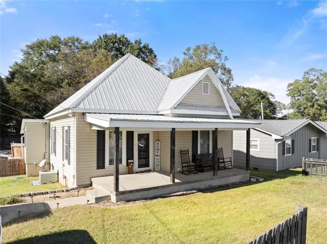 a view of a house with pool and sitting area