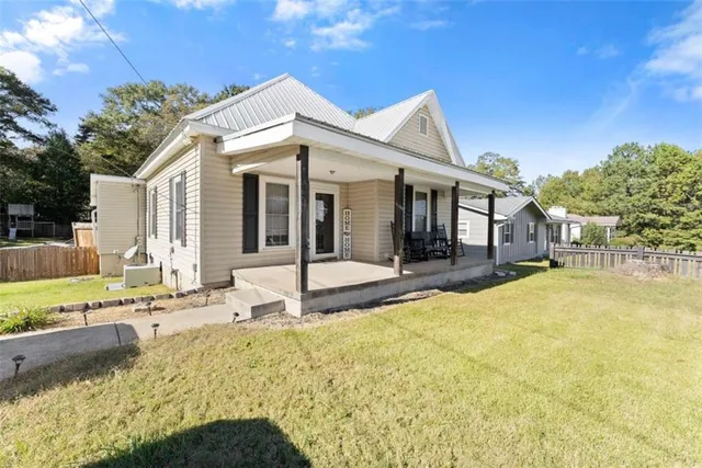 a view of a house with pool and sitting area