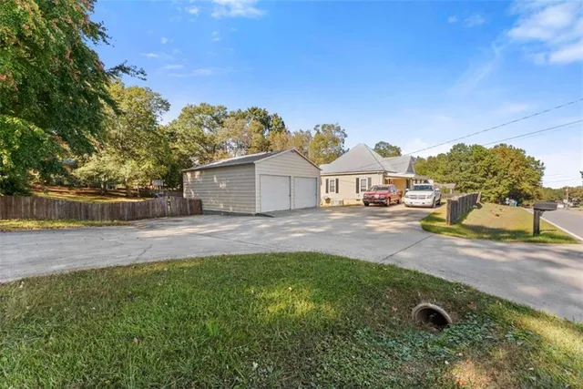 a view of a house with backyard and a tree