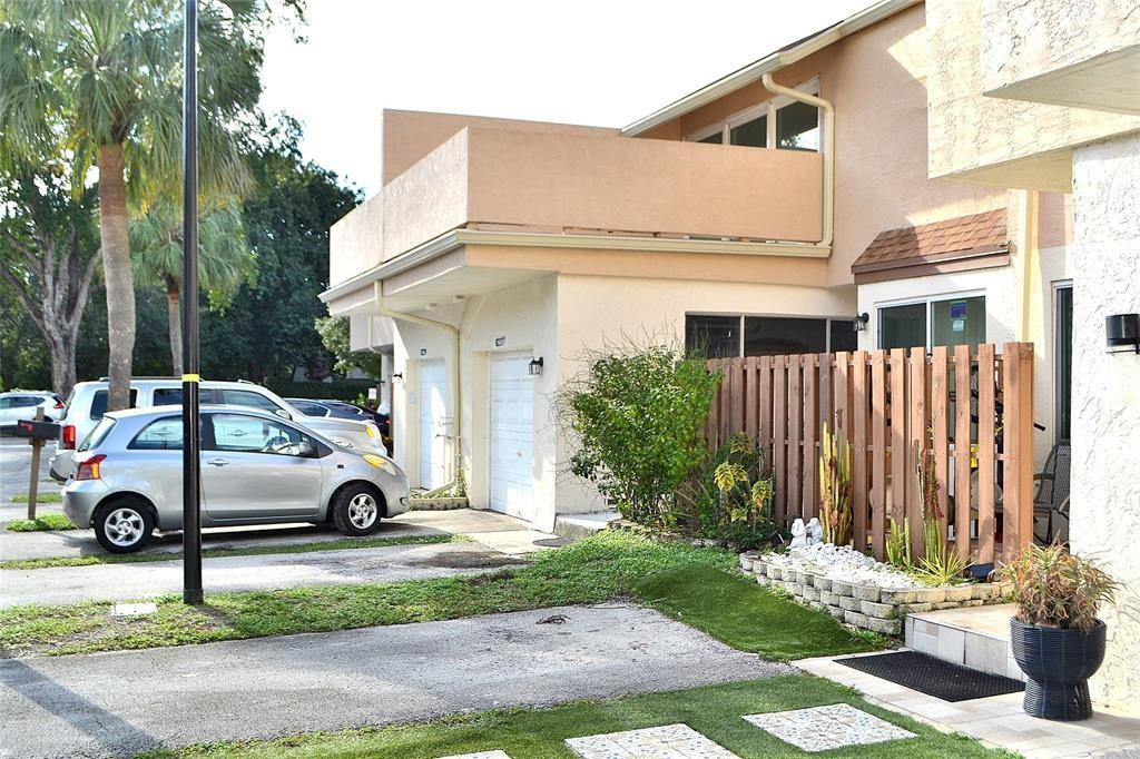 8237 Northwest 8th Court, Unit 4 Plantation, FL 33324 - Photo 1 of 24 a car parked in front of a white house