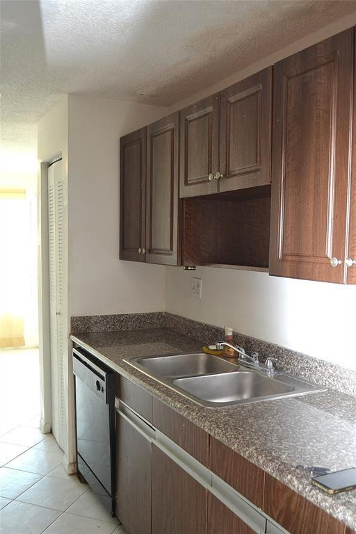 8237 Northwest 8th Court, Unit 4 Plantation, FL 33324 - Photo 3 of 24 a kitchen with granite countertop a sink dishwasher stove and cabinets with wooden floor