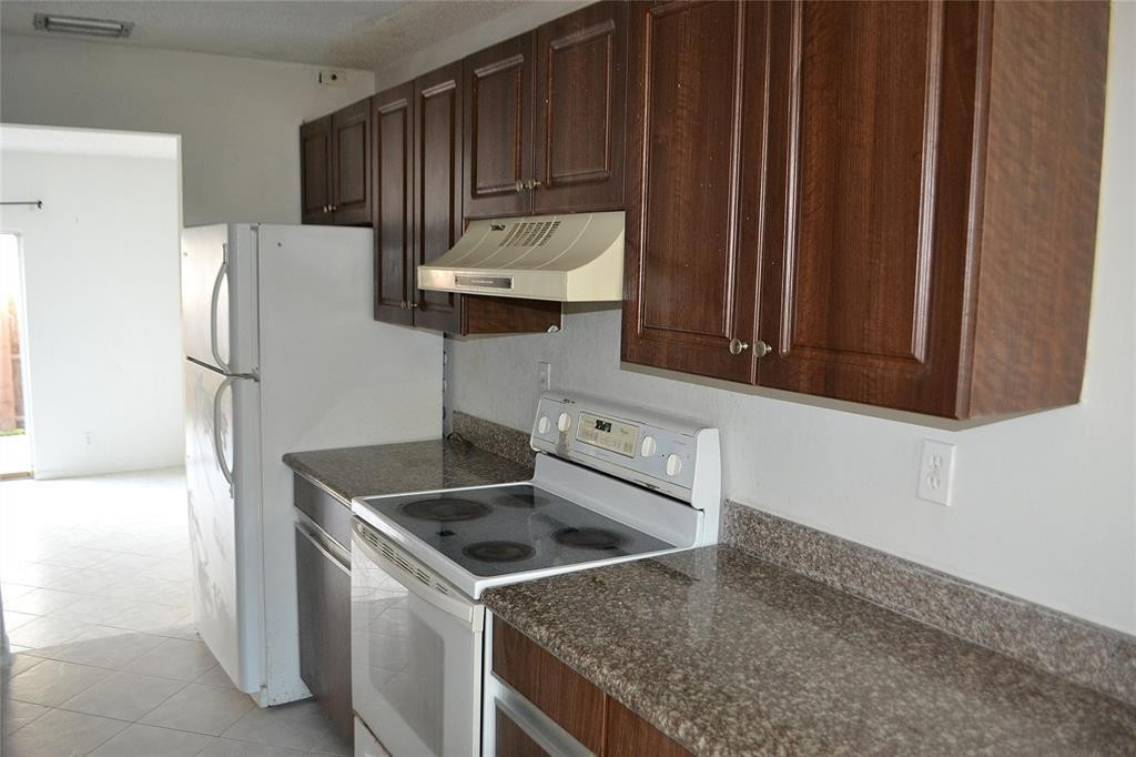 8237 Northwest 8th Court, Unit 4 Plantation, FL 33324 - Photo 4 of 24 a kitchen with stainless steel appliances granite countertop a sink stove and refrigerator