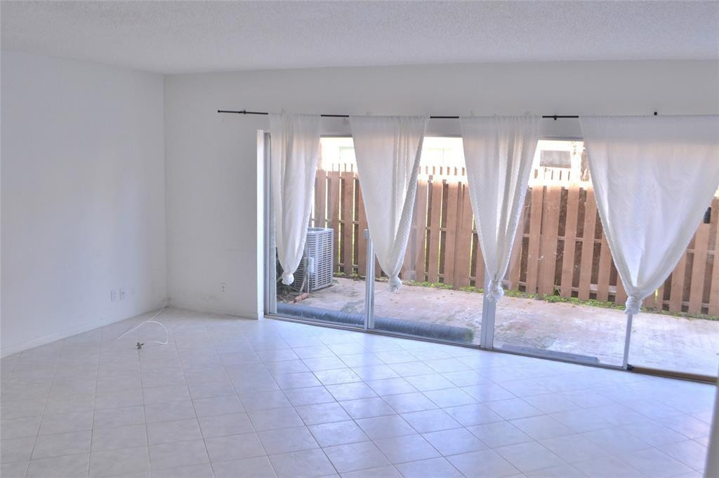 8237 Northwest 8th Court, Unit 4 Plantation, FL 33324 - Photo 5 of 24 a view of an empty room with windows