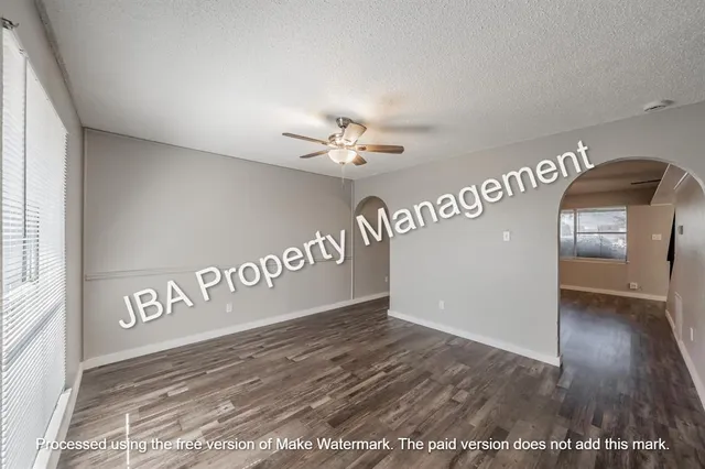 a kitchen with granite countertop a stove and a wooden cabinets