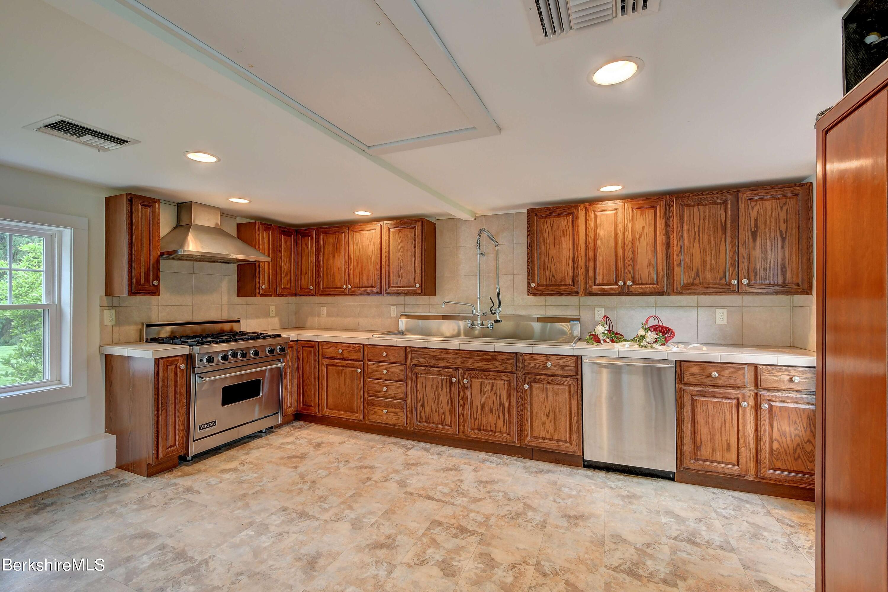 1 Devon Road Stockbridge, MA 01262 - Photo 53 of 58 a kitchen with stainless steel appliances granite countertop a stove sink and cabinets