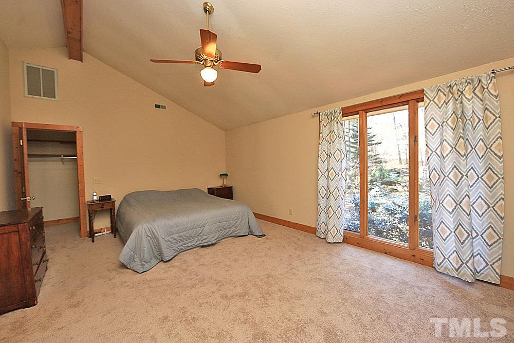 11716 Appaloosa Run East Raleigh, NC 27613 - Photo 15 of 30 Large master bedroom with vaulted ceiling has lovely light and views of private backyard.
