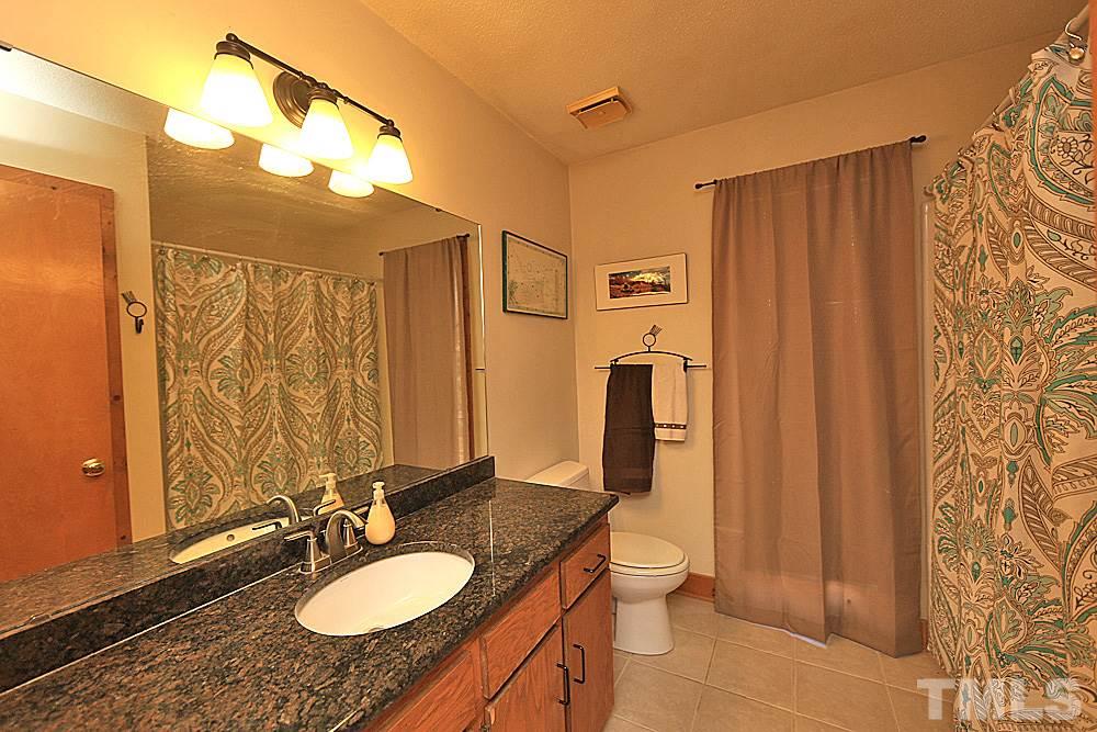 11716 Appaloosa Run East Raleigh, NC 27613 - Photo 17 of 30 Full bathroom conveniently located between the two downstairs bedrooms on the main floor. Lovely granite countertop.