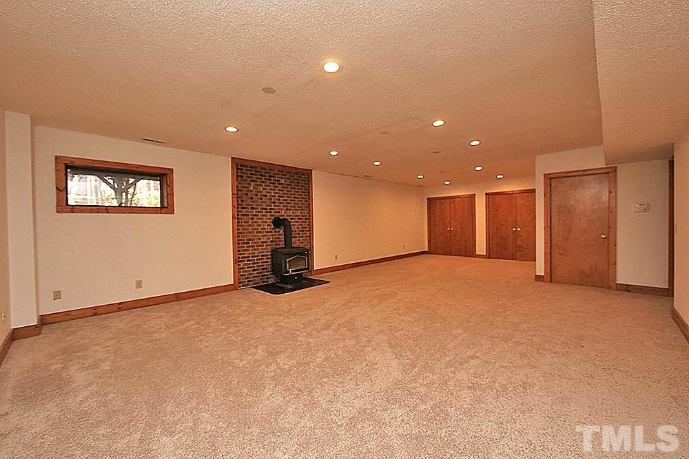 11716 Appaloosa Run East Raleigh, NC 27613 - Photo 20 of 30 Finished basement has new carpet, a separate HVAC system and a wood burning stove. Wonderful additional area for recreation and living.