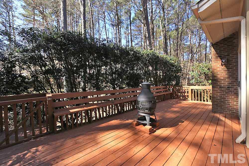 11716 Appaloosa Run East Raleigh, NC 27613 - Photo 24 of 30 Large deck overlooks wooded backyard with custom bench area for sitting.