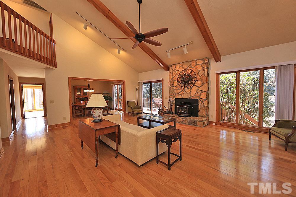 11716 Appaloosa Run East Raleigh, NC 27613 - Photo 5 of 30 Open and spacious family room with beautiful hardwoods floors, stone wood burning fireplace perfect for entertaining.