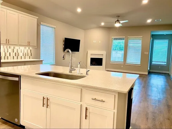 a view of kitchen and a sink with wooden floor