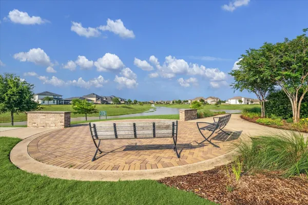 a view of a house with a entertaining space and a large tree