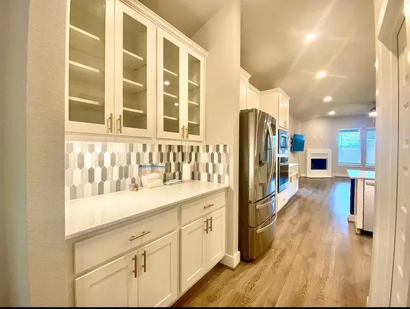 a kitchen with stainless steel appliances cabinets and a window