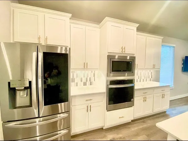 a kitchen with stainless steel appliances a sink and a stove