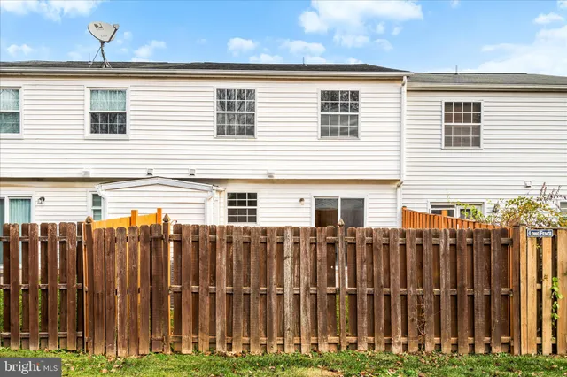 a view of a house with a wooden fence