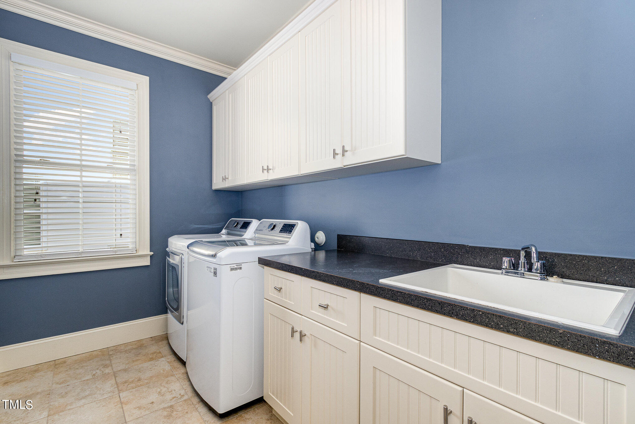 7814 Monument Lane Raleigh, NC 27615 - Photo 34 of 52 2nd floor laundry with sink. Washer & dryer convey.