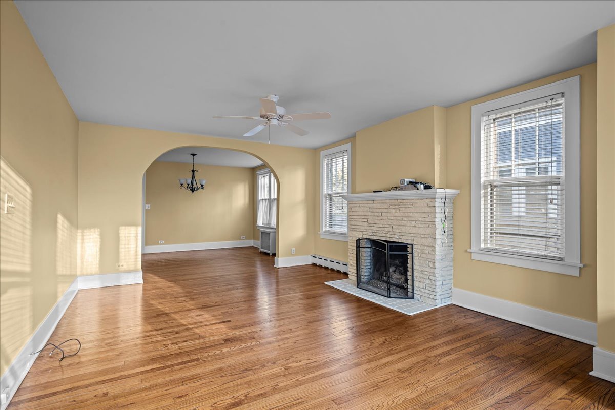 1211 Griffith Road Lake Forest, IL 60045 - Photo 4 of 15 a view of a livingroom with wooden floor a fireplace and windows