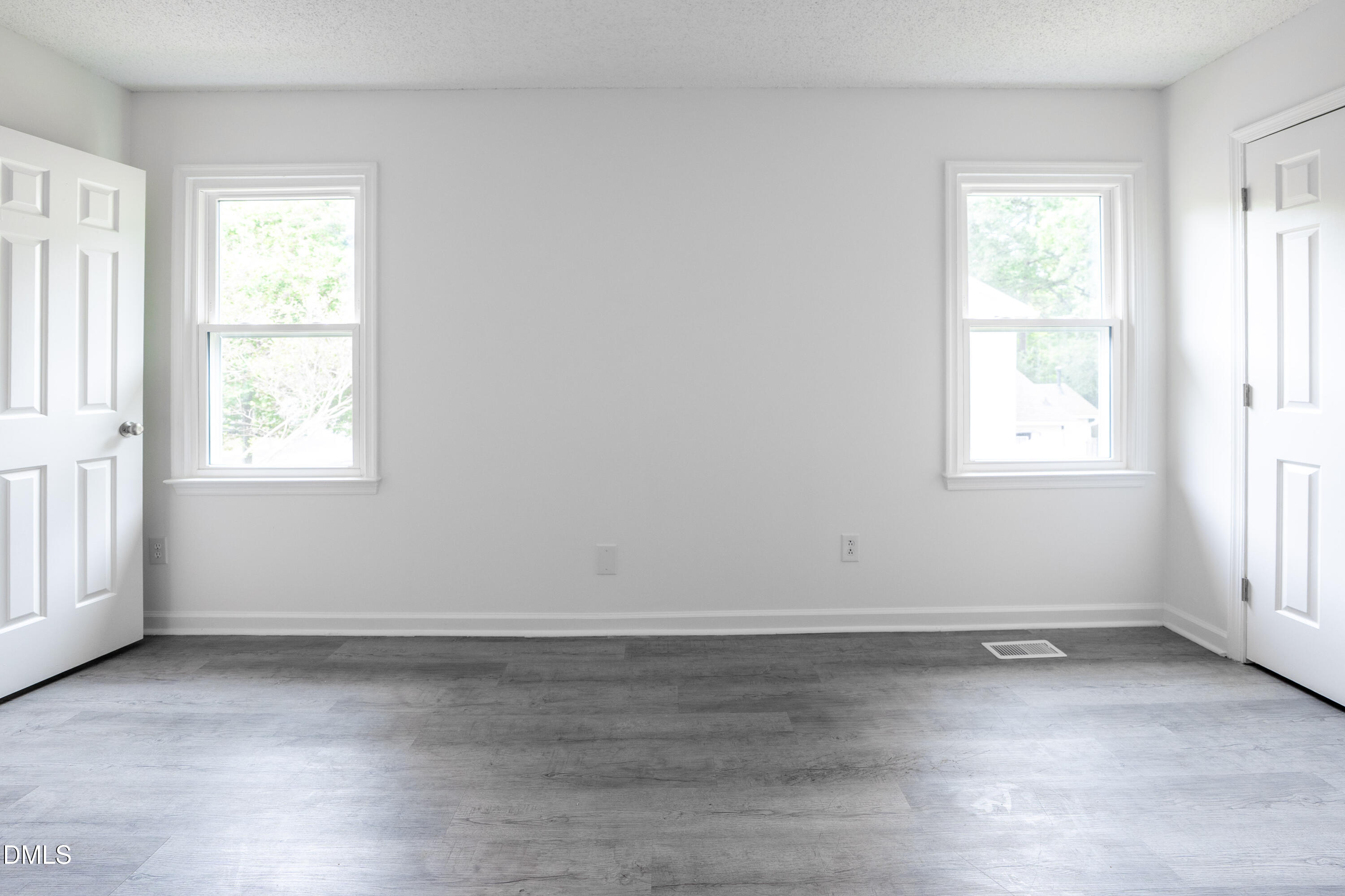 6901 Saxby Court Raleigh, NC 27613 - Photo 12 of 36 an empty room with wooden floor and windows