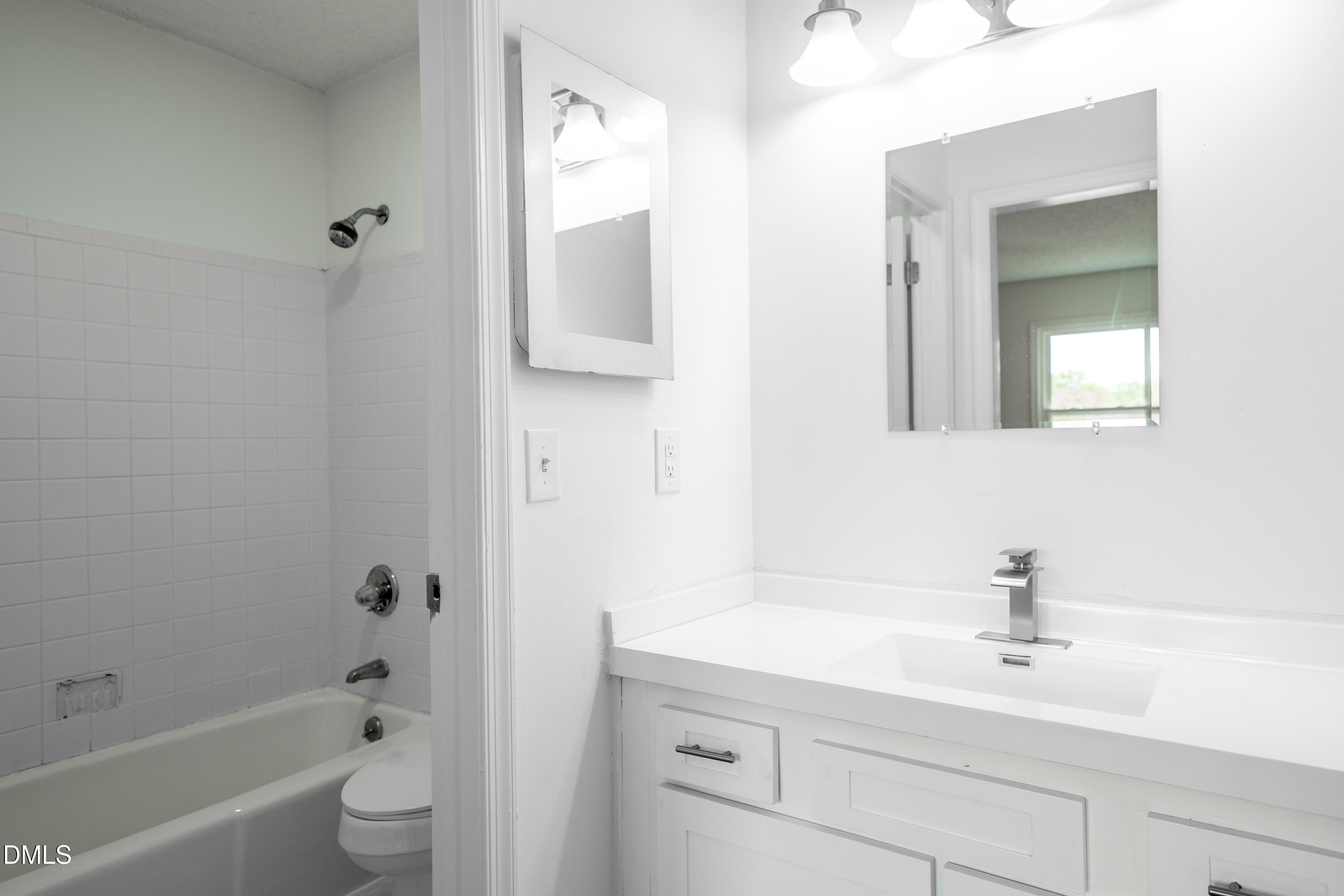 6901 Saxby Court Raleigh, NC 27613 - Photo 18 of 36 a bathroom with a sink a toilet and shower