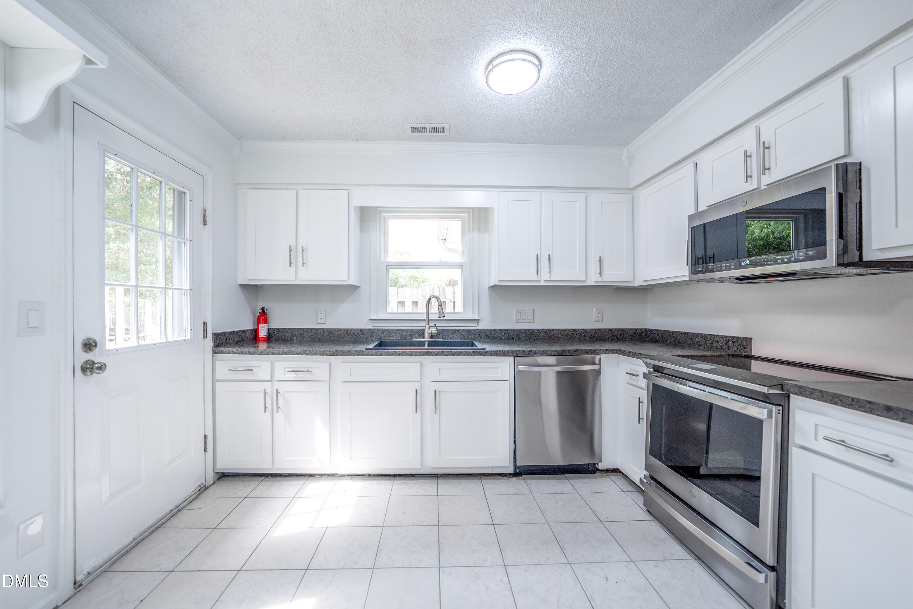 6901 Saxby Court Raleigh, NC 27613 - Photo 19 of 36 a kitchen with cabinets appliances and a window