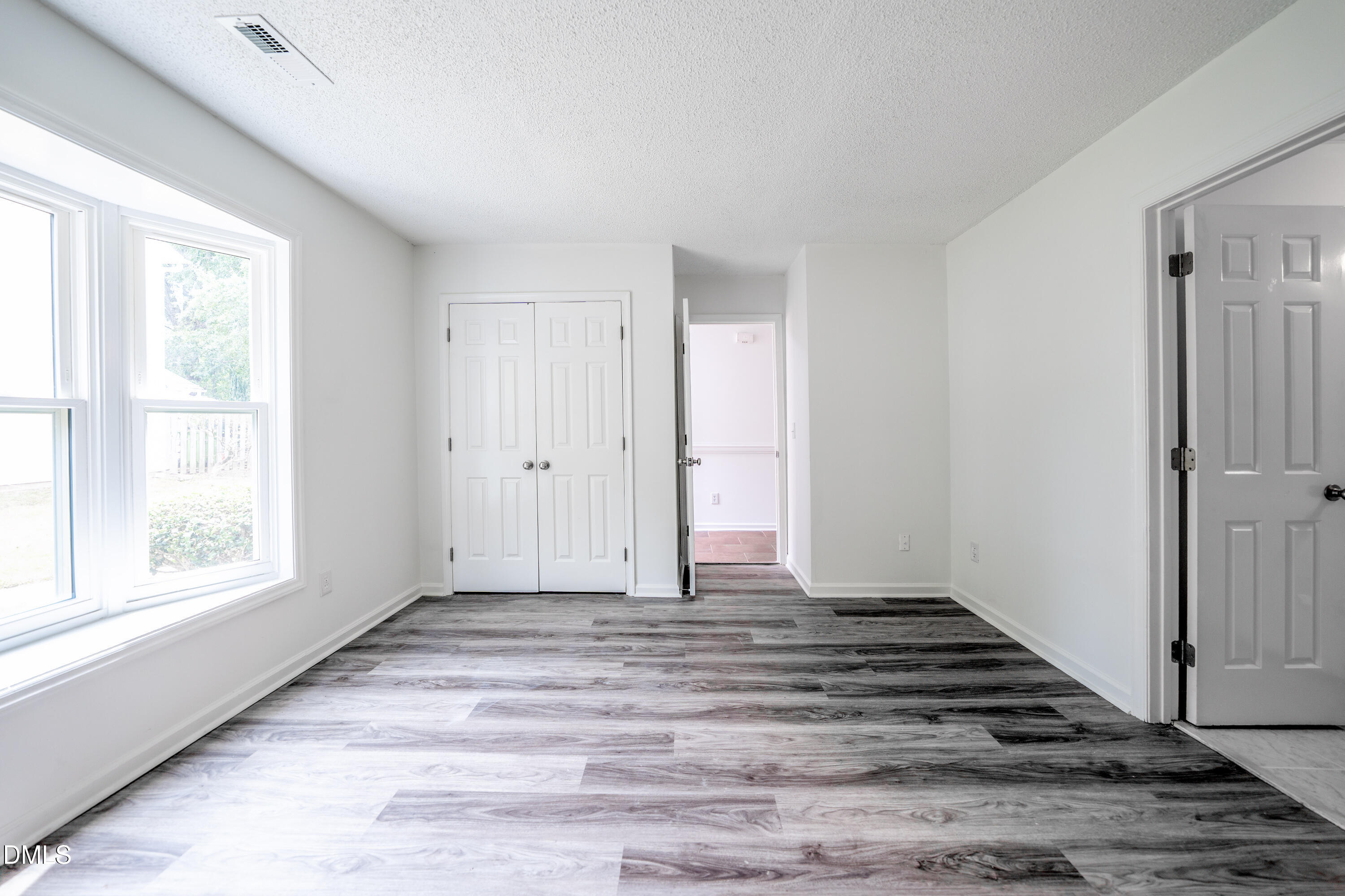 6901 Saxby Court Raleigh, NC 27613 - Photo 22 of 36 a view of a livingroom with wooden floor and window