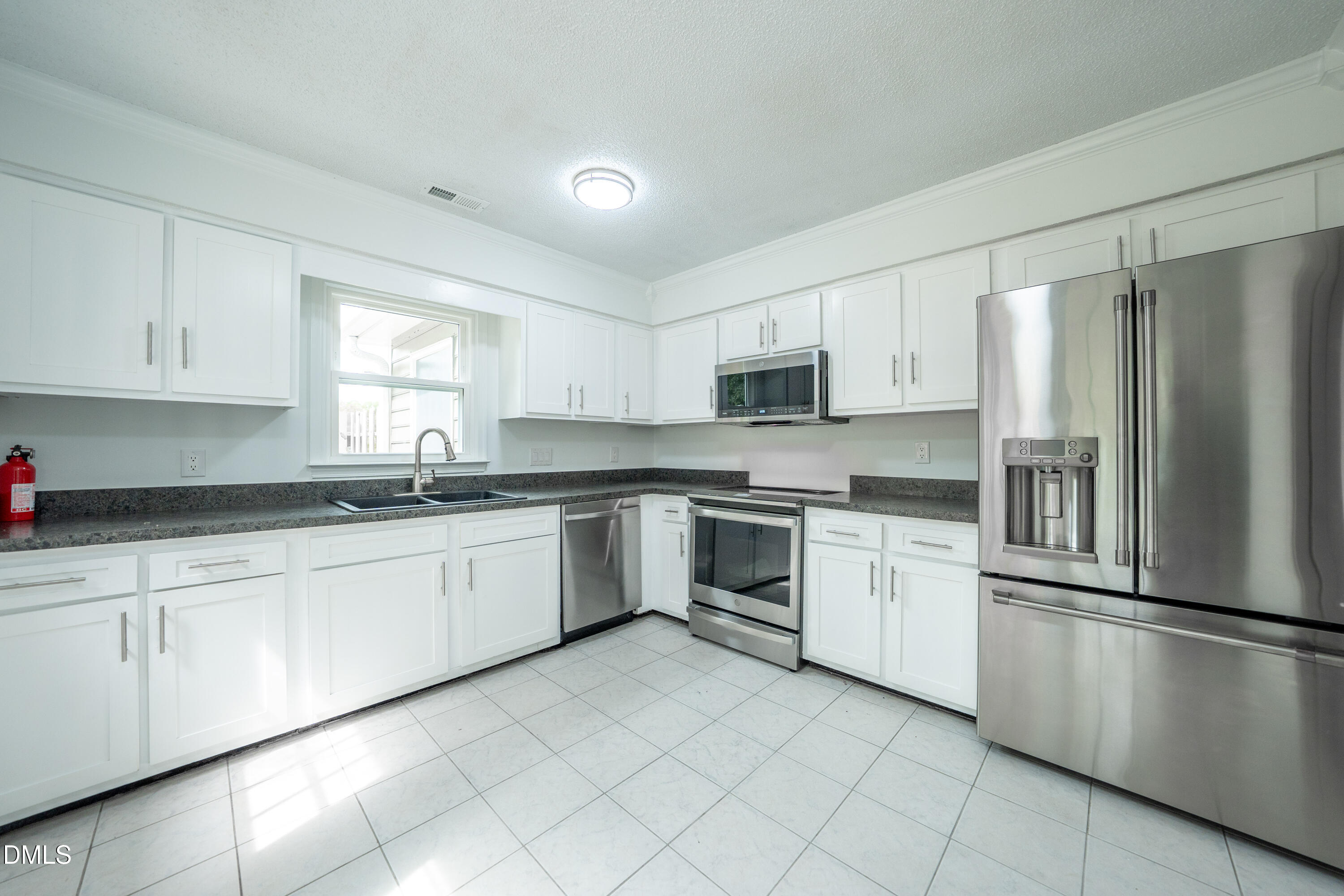 6901 Saxby Court Raleigh, NC 27613 - Photo 2 of 36 a kitchen with granite countertop cabinets stainless steel appliances and a window