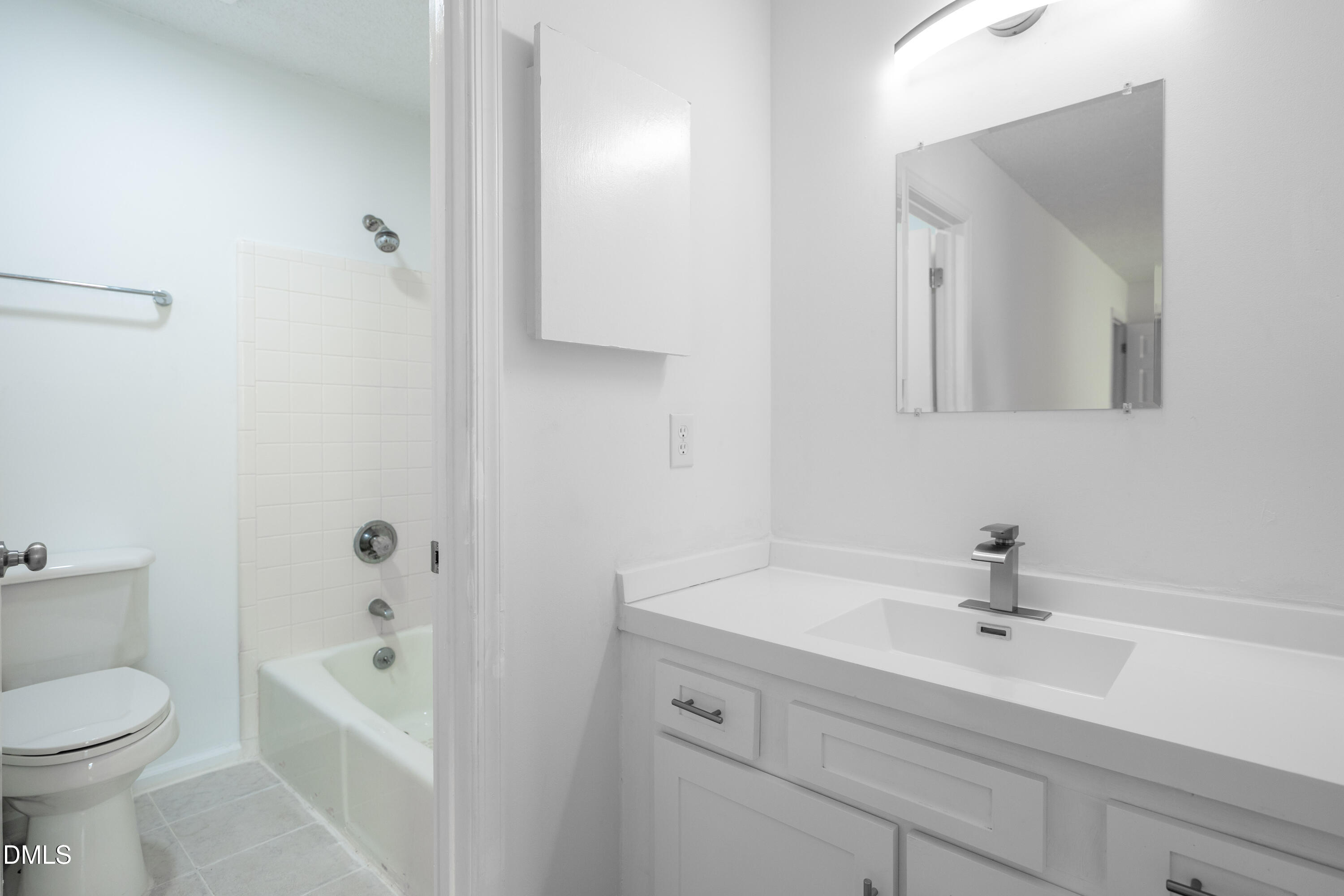 6901 Saxby Court Raleigh, NC 27613 - Photo 6 of 36 a bathroom with a sink a toilet and shower