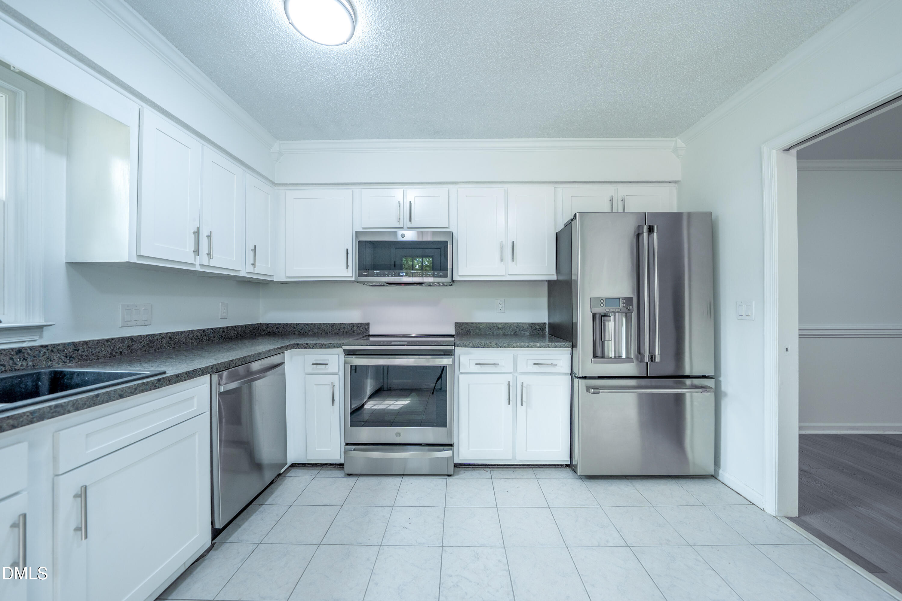 6901 Saxby Court Raleigh, NC 27613 - Photo 7 of 36 a kitchen with stainless steel appliances granite countertop a refrigerator and a stove top oven