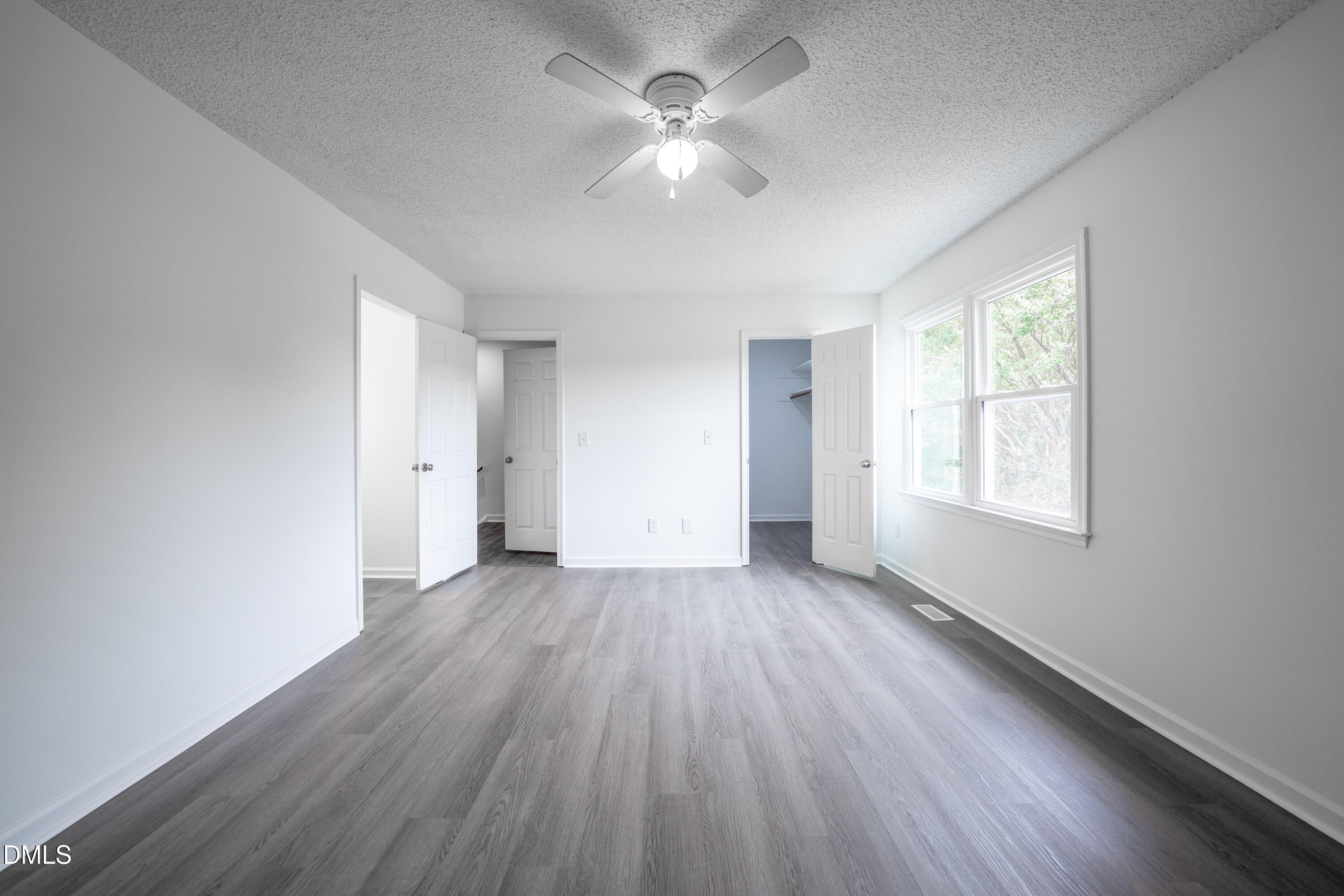 6901 Saxby Court Raleigh, NC 27613 - Photo 8 of 36 an empty room with wooden floor and windows