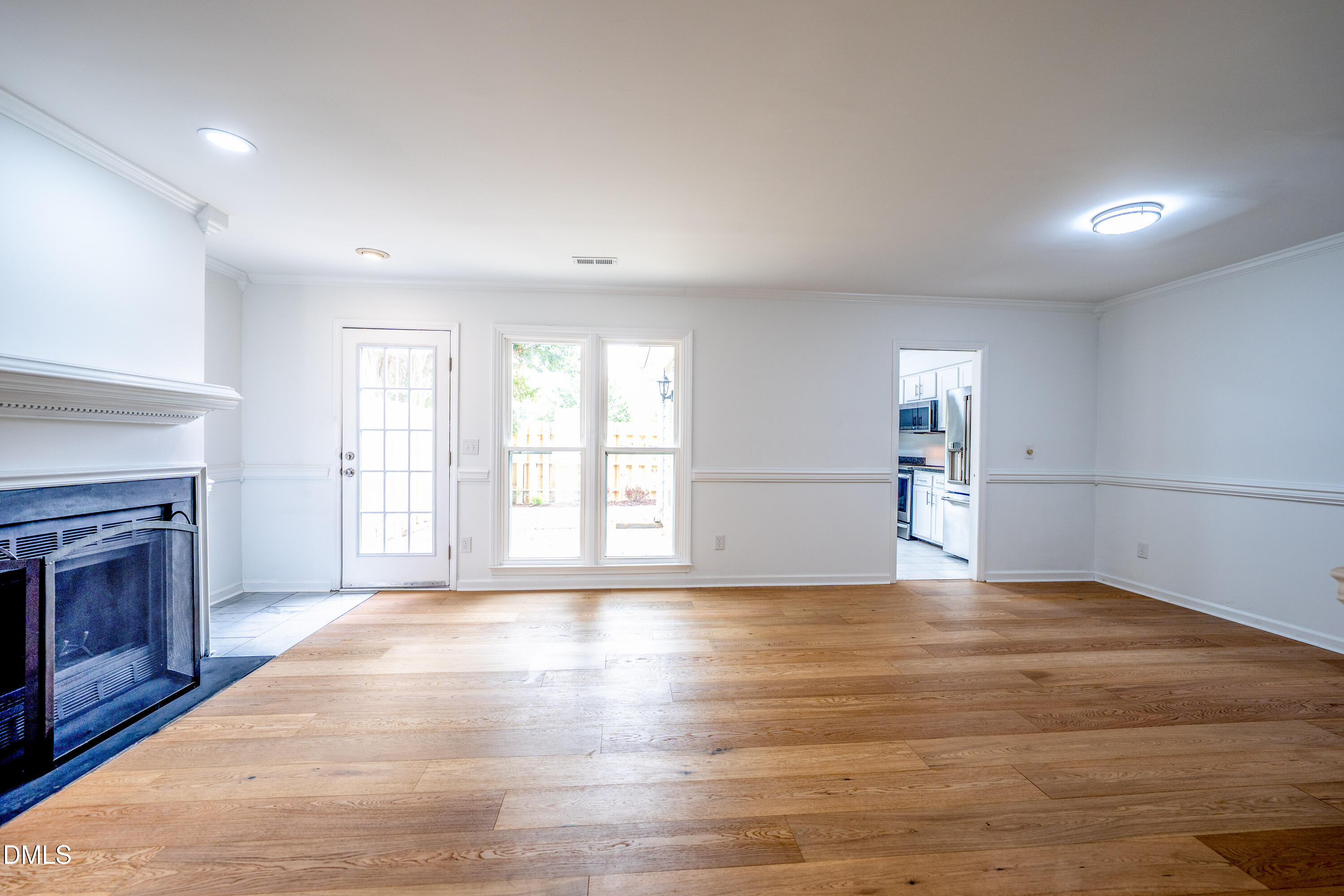 6901 Saxby Court Raleigh, NC 27613 - Photo 9 of 36 a view of an empty room with a fireplace and a window
