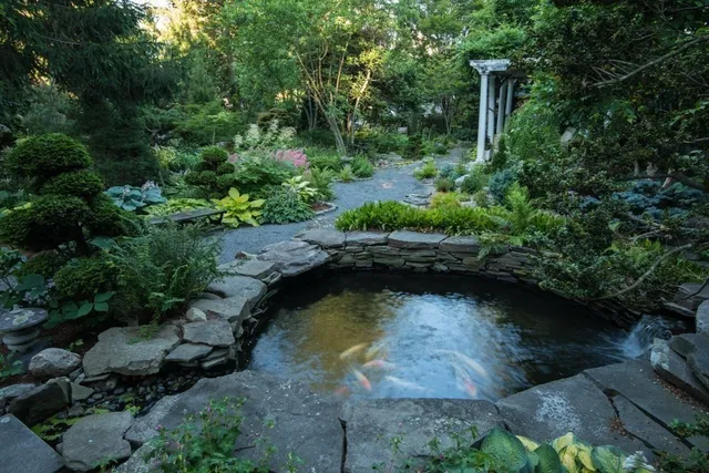 an aerial view of a house with a yard basket ball court and outdoor seating