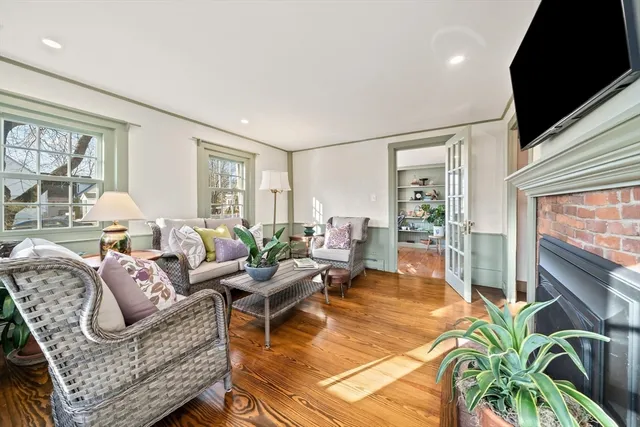 a living room with furniture fireplace and flat screen tv