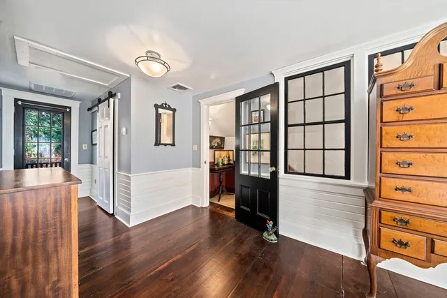a bathroom with a granite countertop sink a toilet and mirror