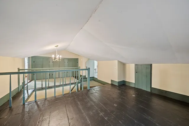 a view of an empty room with window and furniture
